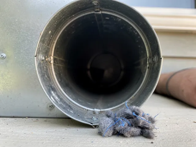 Los Angeles Dryer Vent Cleaning technician using specialized equipment to clear severe dryer vent blockage in Los Angeles